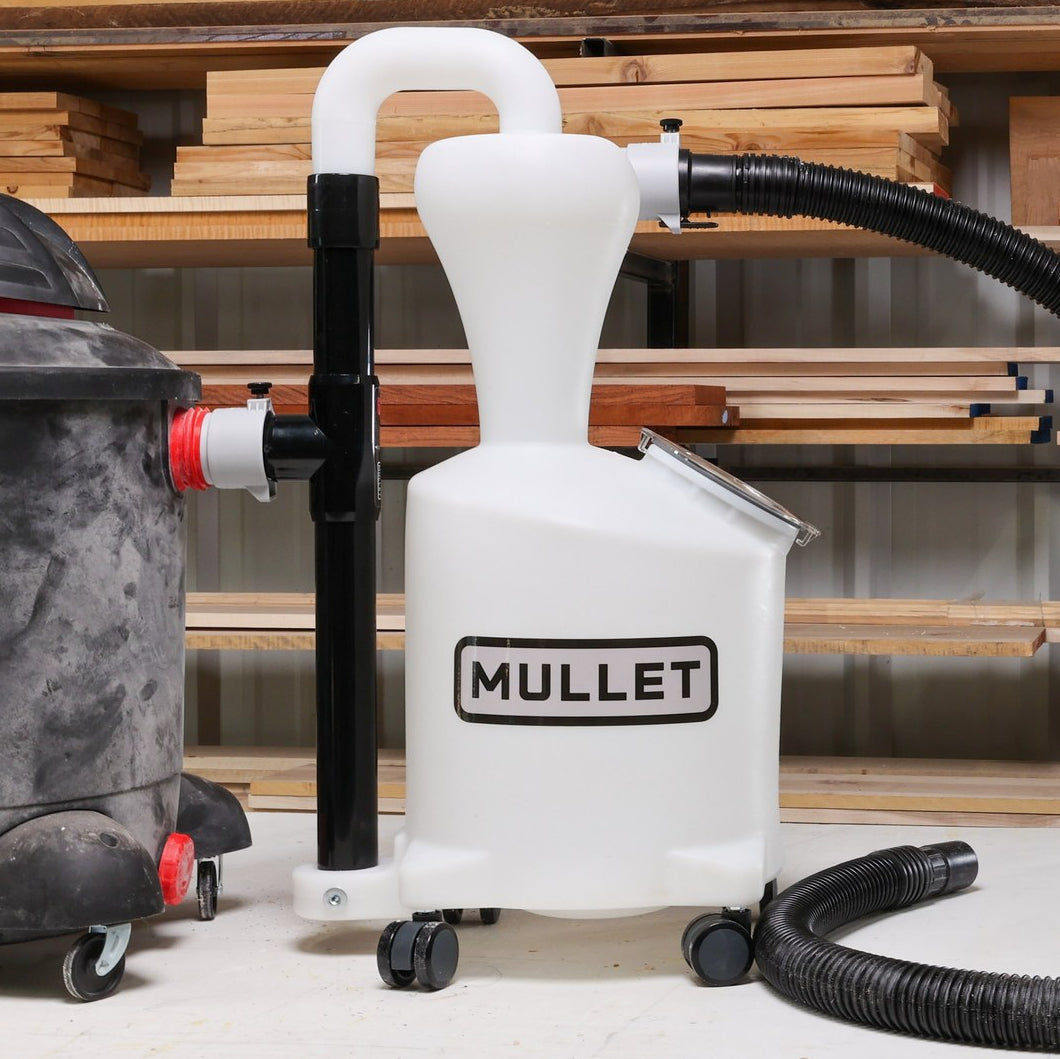 Mullet High-Speed Cyclone Dust Collector connected via a rigid PVC pipe to a Shop Vac shop vacuum in a woodshop